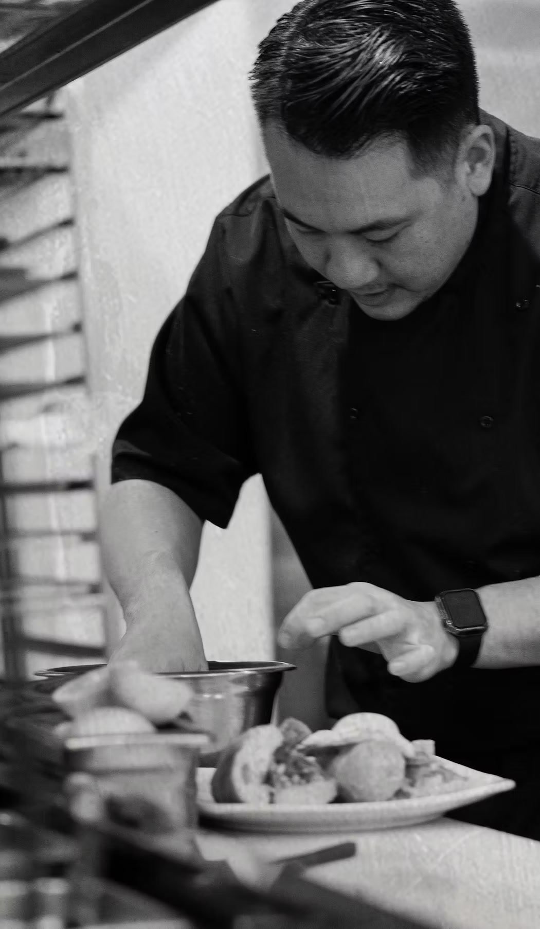 Executive Chef Danny Le of Chez Bacchus, plating in the kitchen
